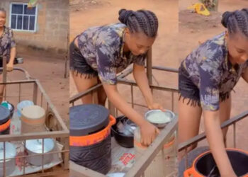 Pretty Nigerian lady stir reactions as she help her mum to sell food on bum shorts 