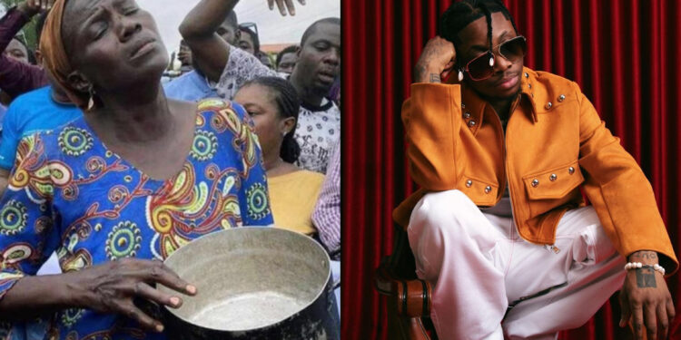 Oxlade melts hearts as he gifts a woman, who came to protest with an empty pot, N500k