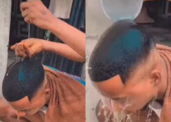 Nigerian barber is seen using egg to wash the head of his client after giving him amazing haircut