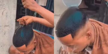 Nigerian barber is seen using egg to wash the head of his client after giving him amazing haircut