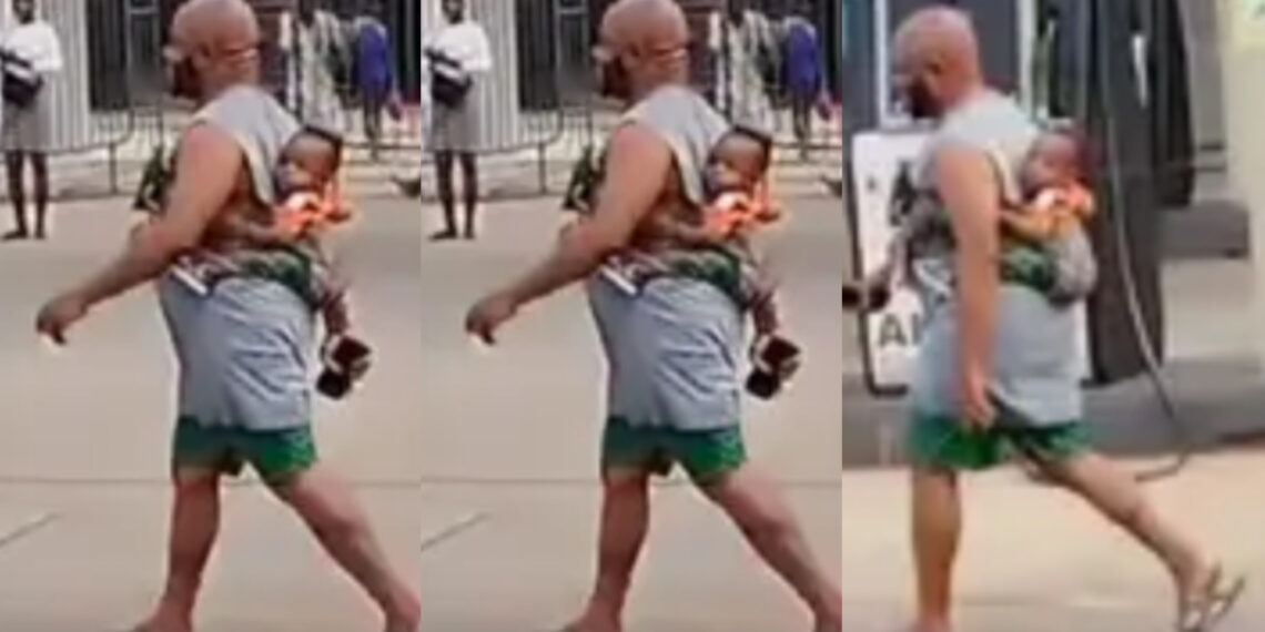 A heartwarming moment a father trekking with a baby at his back sparks admiration online