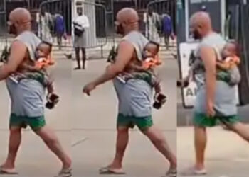 A heartwarming moment a father trekking with a baby at his back sparks admiration online
