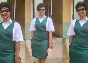57 years old Lady,raised eyebrows as she dresses up in uniform as she attends her secondary school’s 40th reunion